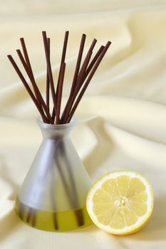 Wooden sticks in essential oil with lemon