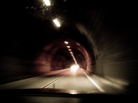 Action point of view shot of interior of tunnel with lights extending into the horizon