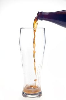 pouring dark wheat beer in a glass