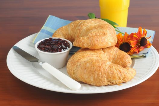 Fresh baked flaky croissants served with jam.