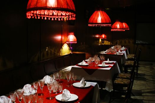 The cozy interior of the restaurant with red lights