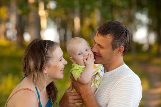 Young happy family in wood