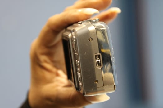 Close up of woman's hand holding digital camera.