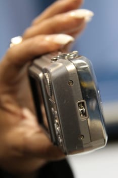 Close up of woman's hand holding digital camera.