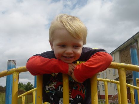 happy little boy playing at the playground