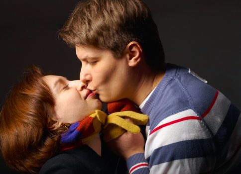 The young man kissing the woman