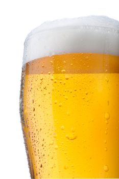 Fresh glass of pils beer with froth and condensed water pearls isolated on white background 
