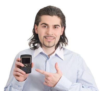 Young dark haired caucasian man in light blue striped shirt points at mobile phone and smiles isolated on white