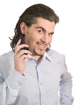Young dark haired caucasian man in light blue striped shirt holds mobile phone and smiles isolated on white