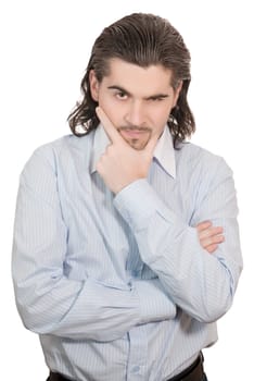 Young worried dark haired businessman in light blue striped shirt holds hand on his chin isolated on white