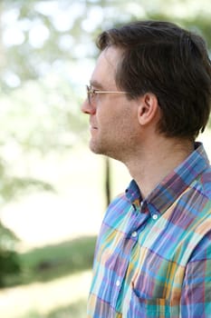 Profile of  man enjoying outdoors in summer, wearing sunglasses