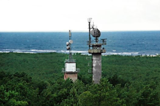 Military radar tower  in the forest near the sea shore