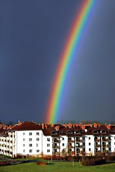 Beautiful, colorful rainbow above housing estate