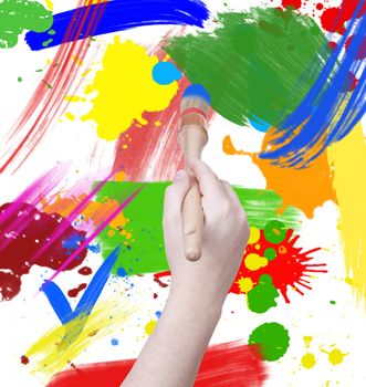 hand holding a painting brush isolated on mixed colour background