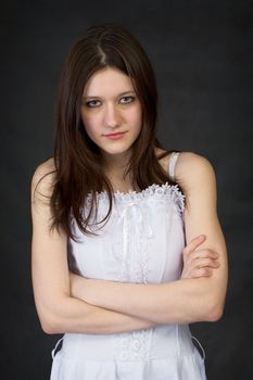 The frowned serious girl on a black background