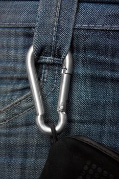 Carabiner climbing with a rope fastened to the jeans