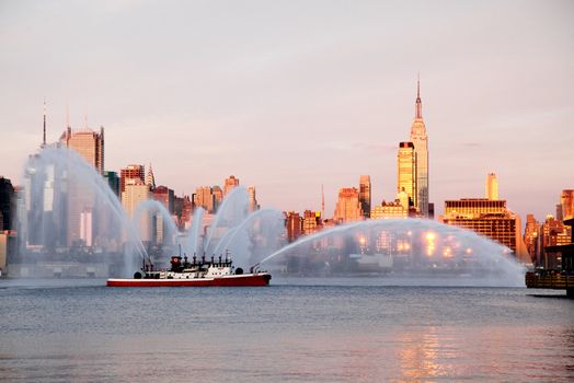 NEW YORK CITY - JULY 4, 2009: Fireboat waterjet show prior to the largest firework in the America - Macy's 4th of July fireworks which featured more than 40,000 shells.