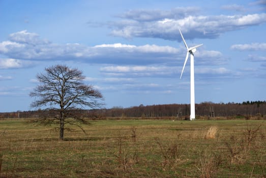 The wind generator on a background of the nature and the sky