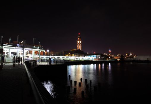 NEW YORK CITY - JULY 4, 2009: The Hoboken train terminal and Empire State Building on background