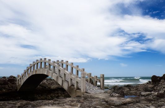 Here is a bridge on the rockland near the sea.