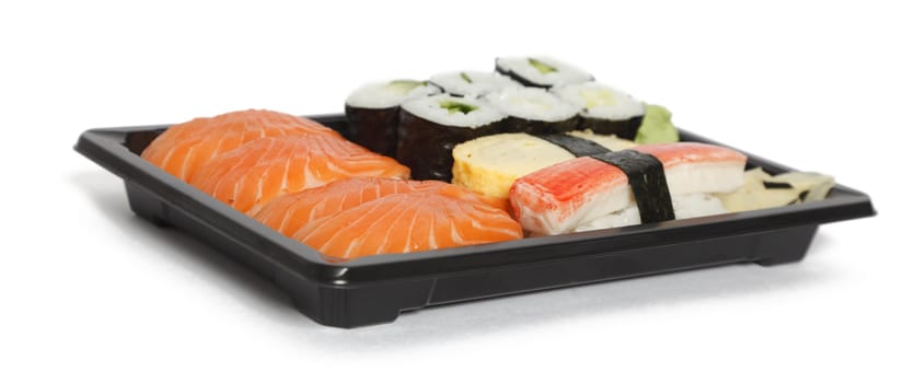 Various types of sushi in a tray isolated against a white background.
