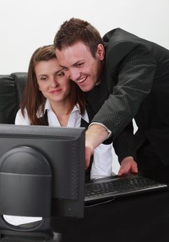 Happpy young businesspersons couple working together on a computer.