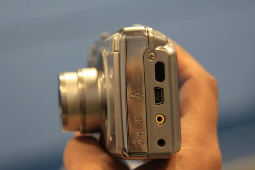 Close up of woman's hand holding digital camera.