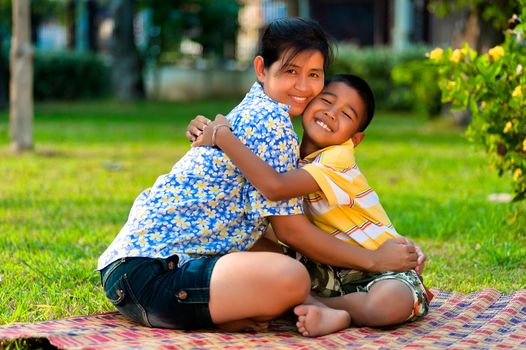 Mother and son play in a park