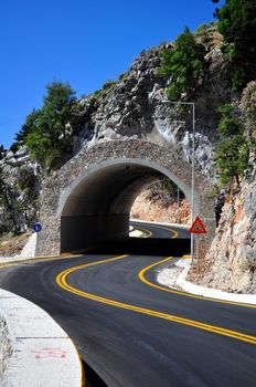 Travel photography: Mountain road passing through a tunnel in the island of 

Crete.