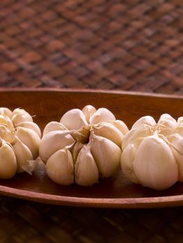 close up of garlic in wooden bowl