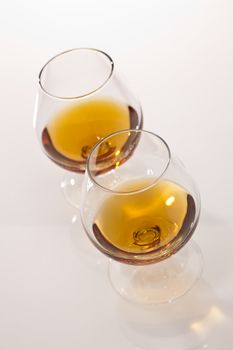 glass of tasty brandy on white