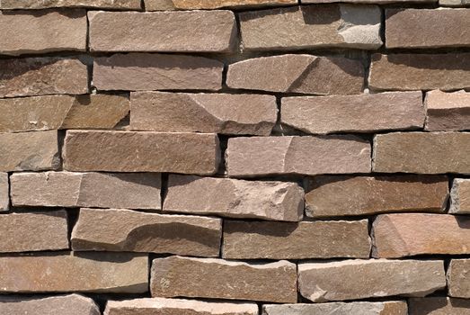 It is a stone wall with brown color.