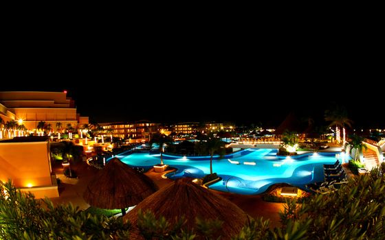 a luxury all inclusive beach resort at night in Cancun Mexico