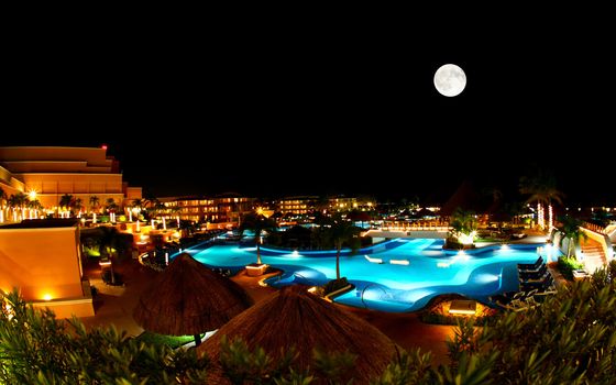 a luxury all inclusive beach resort at night in Cancun Mexico