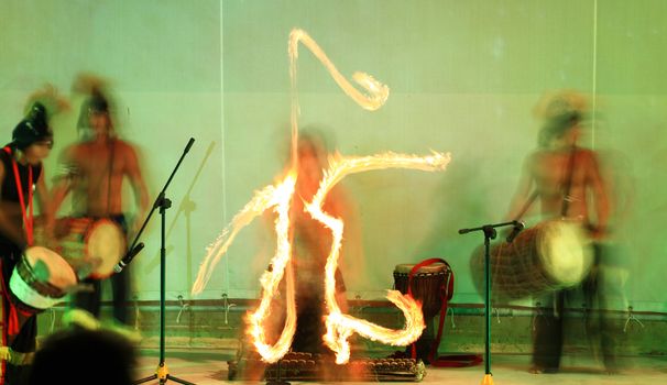 A fire show performed on stage in a beach resort