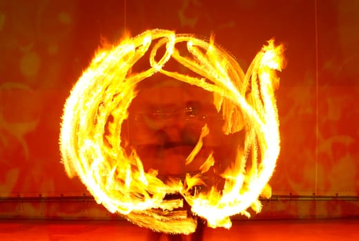 A fire show performed on stage in a beach resort