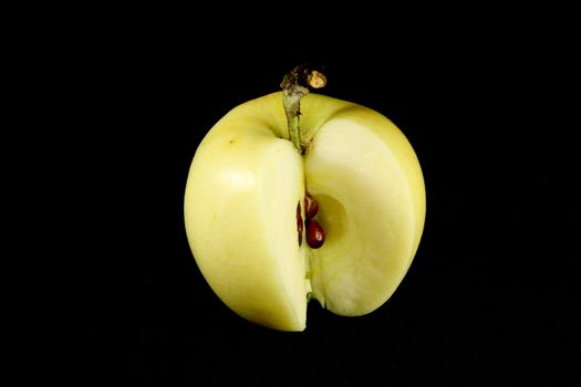 yellow apple on black background