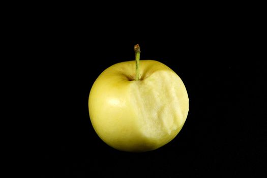 yellow apple on black background