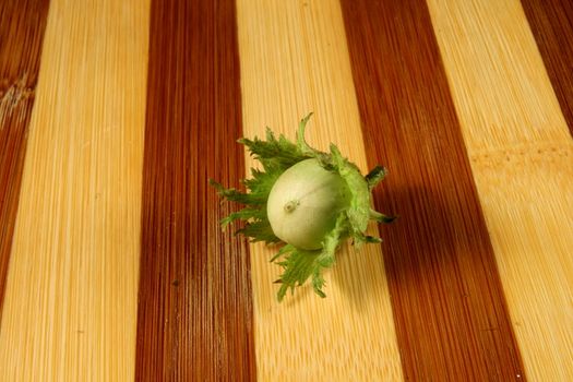 green filbert on wooden surface