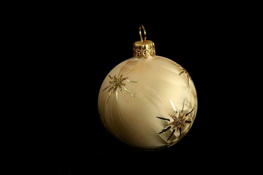 yellow decorative christmas ball isolated on black background