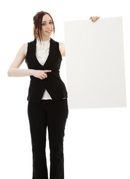 Young business woman wearing a business suit pointing at a white board against white background