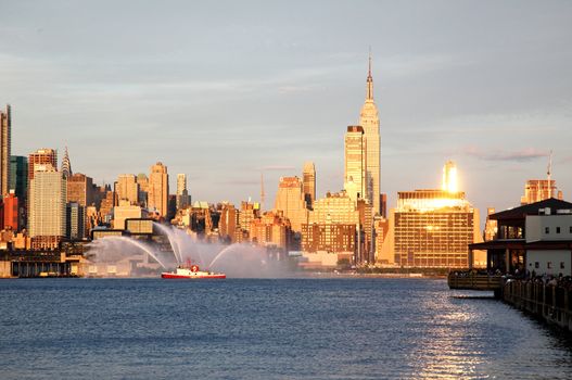 NEW YORK CITY - JULY 4, 2009: Fireboat waterjet show prior to the largest firework in the America - Macy's 4th of July fireworks which featured more than 40,000 shells.