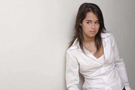 Young woman with white blouse against a white wall