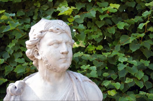 Close-up sideview of a antique statue in a imperial garden in Russia.