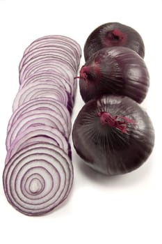 Picture of a couple of red onions with a couple of whole ones at the side