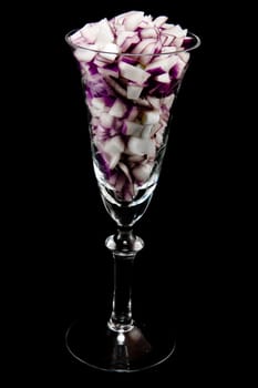 Picture of chopped red onions in a wine glass