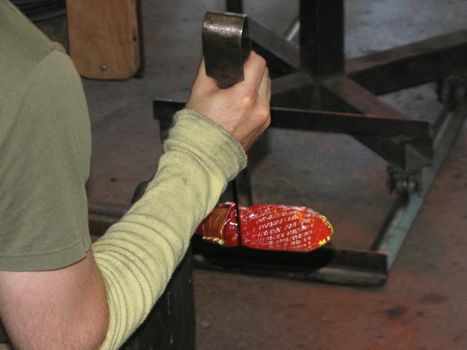A glass blower shapes glass