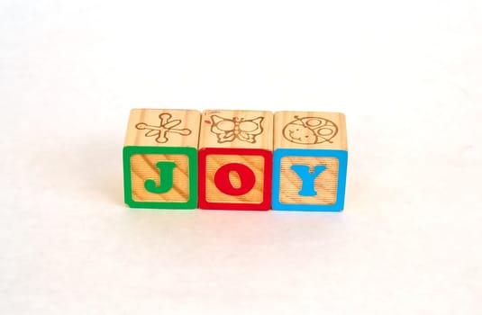Vintage alphabet blocks spelling out JOY