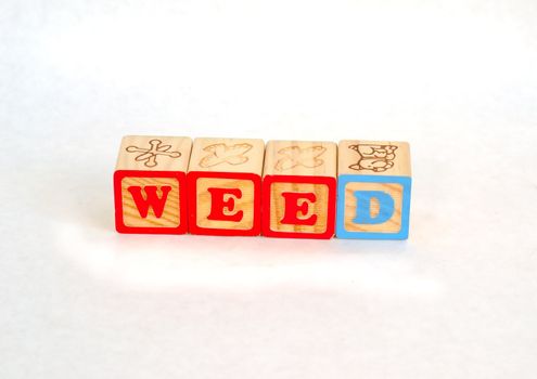 Vintage alphabet blocks spelling out WEED