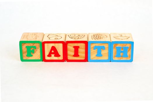 Vintage alphabet blocks spelling out FAITH